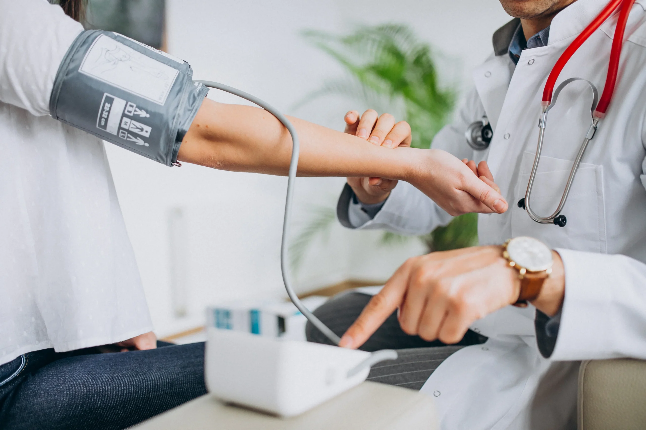 young-male-psysician-with-patient-measuring-blood-pressure-3-scaled